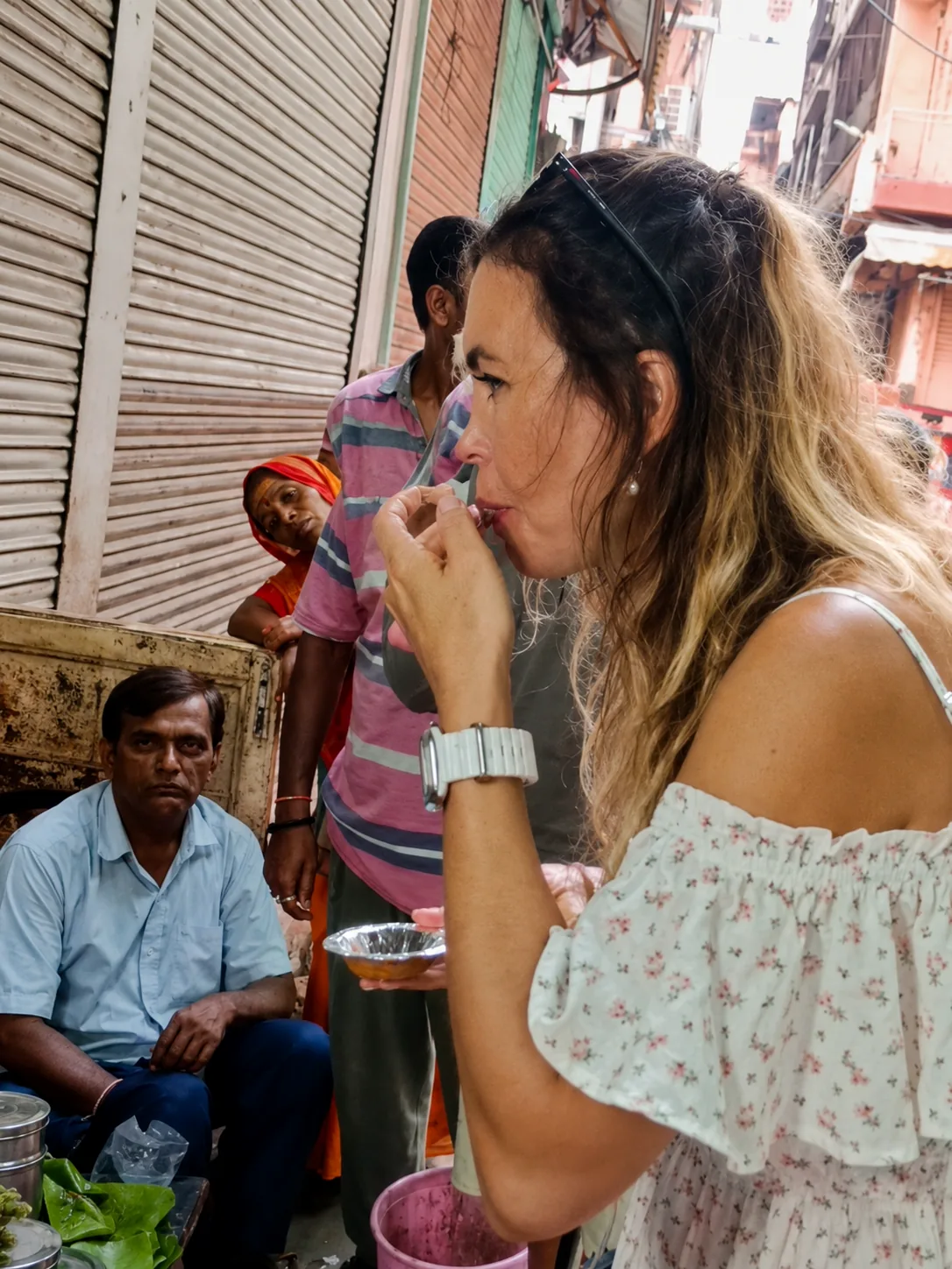 Traveller tasting a local speciality during a guided food walk through old Varanasi