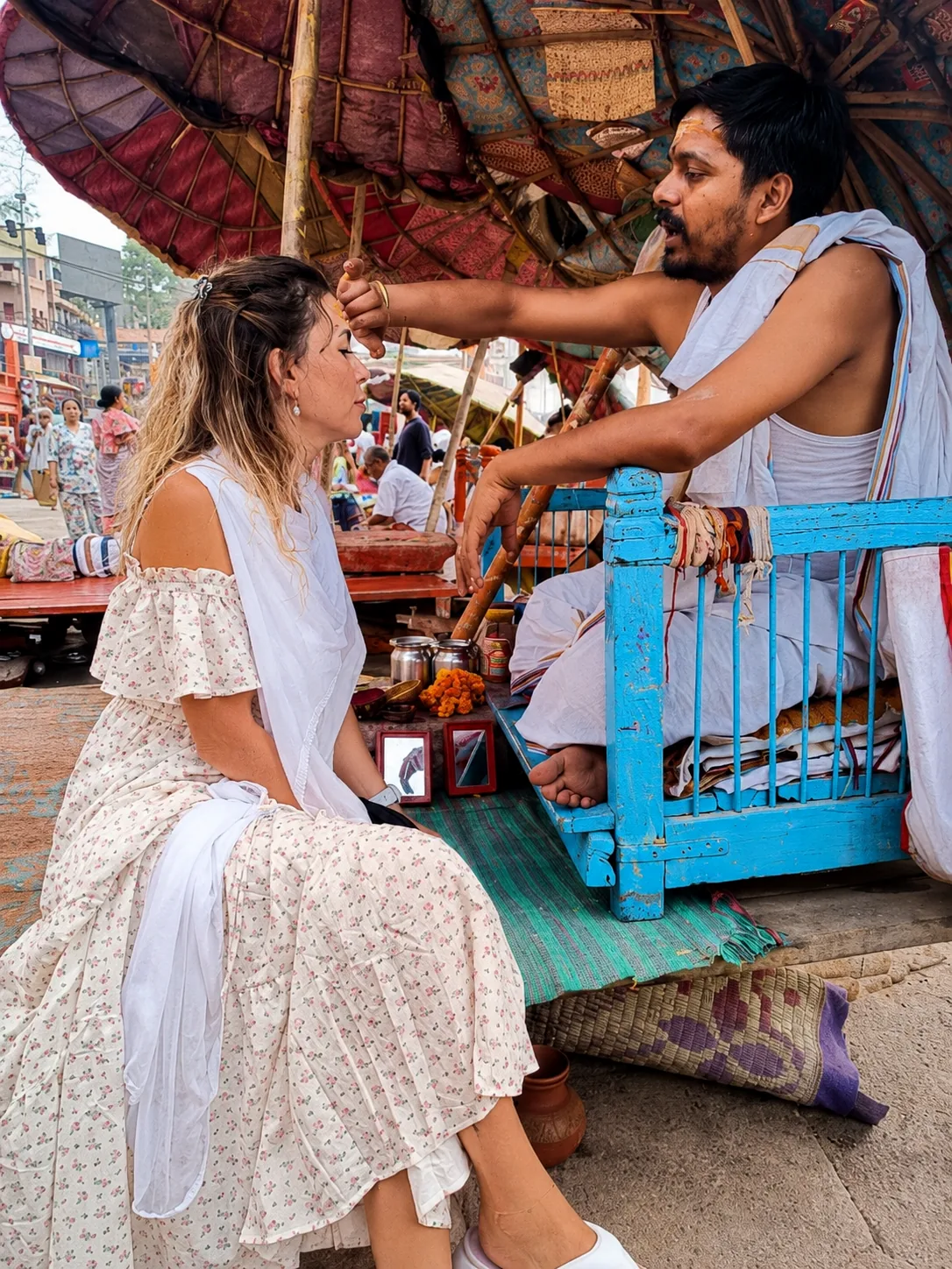 Traveller receiving a traditional tilak during a guided local experience in Varanasi