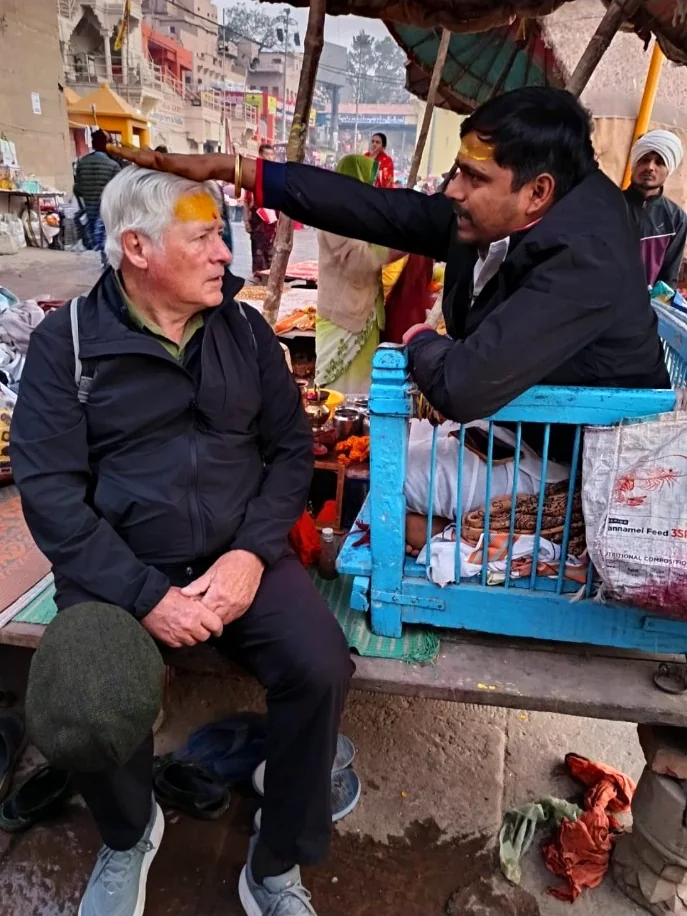 Traveller receiving a tilak from a local priest during a guided walk in Varanasi
