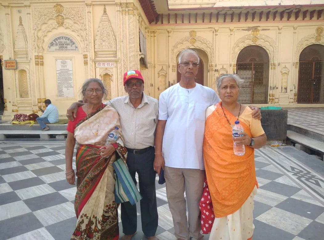 Family posing together in a temple courtyard during an Ayodhya visit