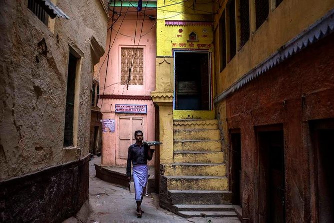 Traveller tasting a local speciality during a guided food walk through old Varanasi