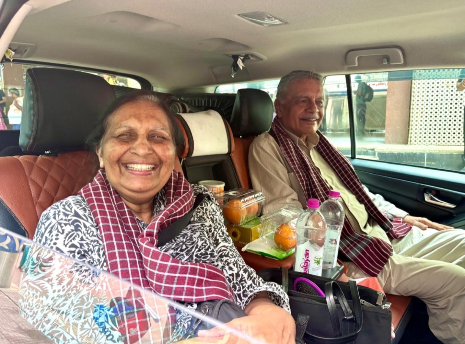 Senior guests travelling comfortably in a private vehicle